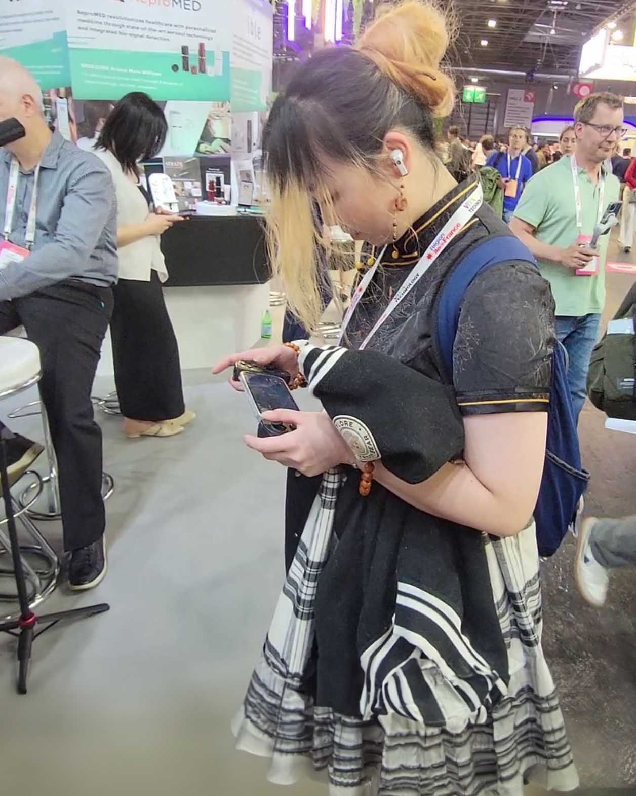 A female booth visitor says the Serafim S3 mobile gaming controller feels like it was made for my hands—so comfortable at Viva Tech 2024